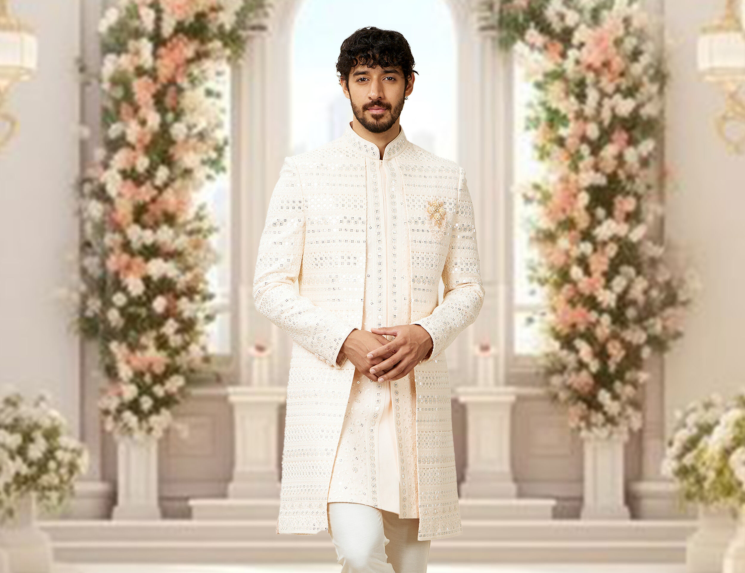 A groom wearing white sherwani for his wedding